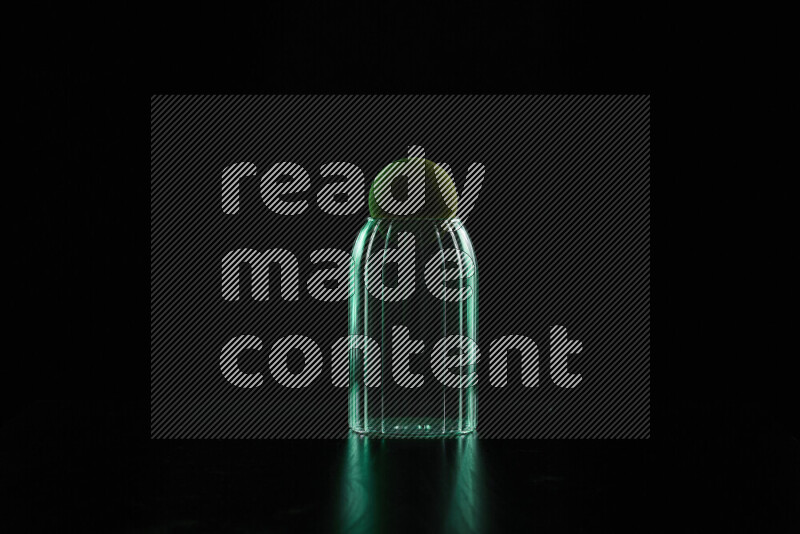 Glassware with rim light in green against black background