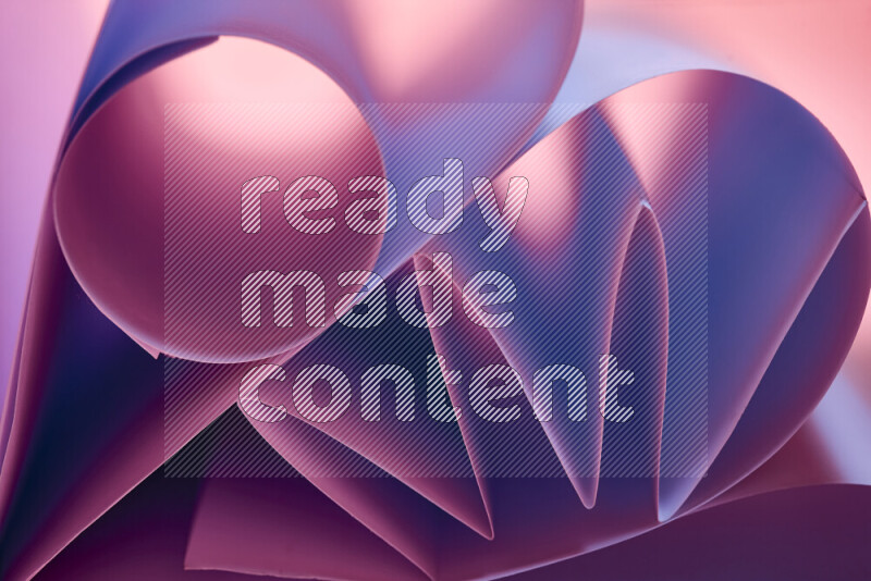 An artistic display of paper folds creating a harmonious blend of geometric shapes, highlighted by soft lighting in purple tones