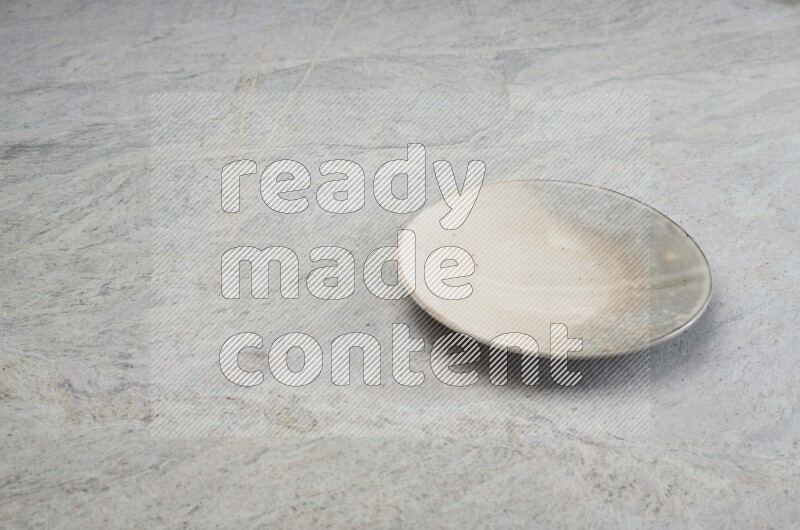 Multicolored Pottery Plate On Grey Marble Flooring
