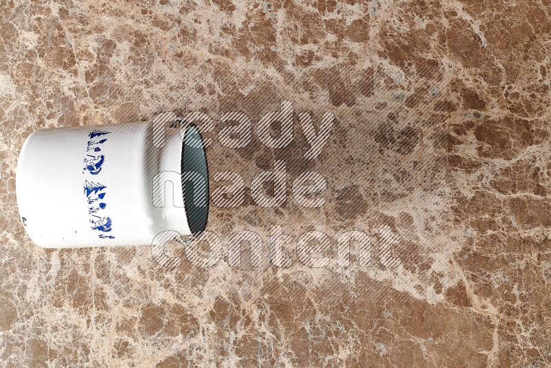 Top View Shot Of A Vintage Milk Can On beige Marble Flooring