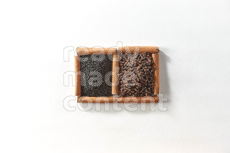 2 squares of cinnamon sticks full of cloves and black seeds on white flooring