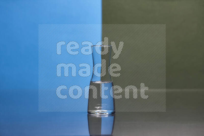 The image features a clear glassware filled with water, set against blue and dark green background