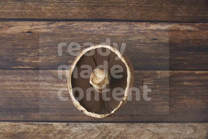 Fresh portobello mushroom topview on a wooden textured background