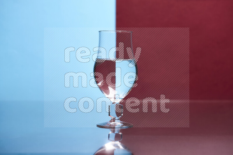 The image features a clear glassware filled with water, set against light blue and dark red background