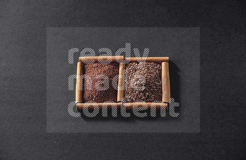 2 squares of cinnamon sticks full of garden cress and flaxseeds on black flooring