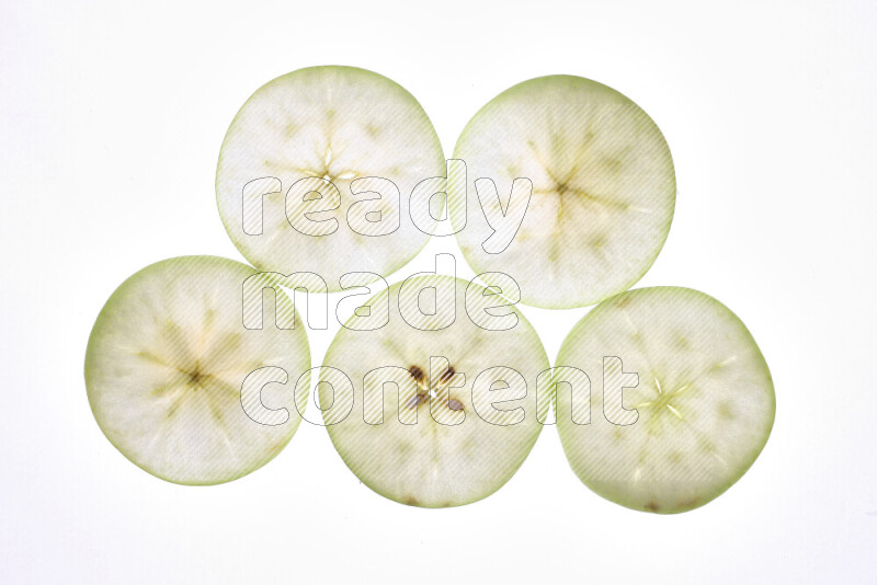 Apple slices on illuminated white background