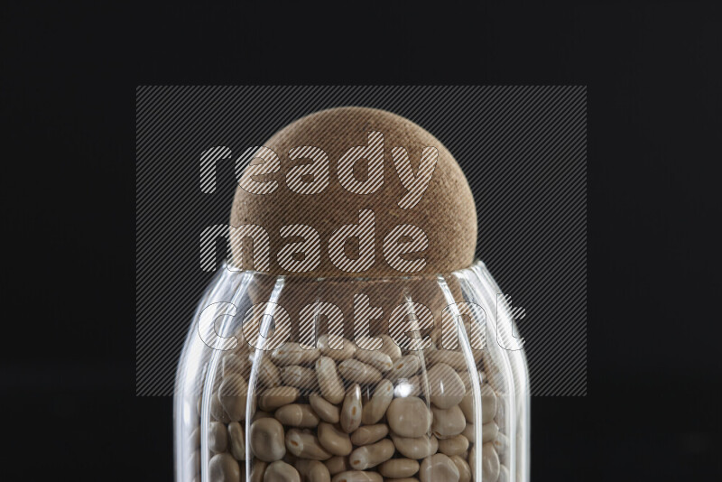 Lupin Beans in a glass jar on black background