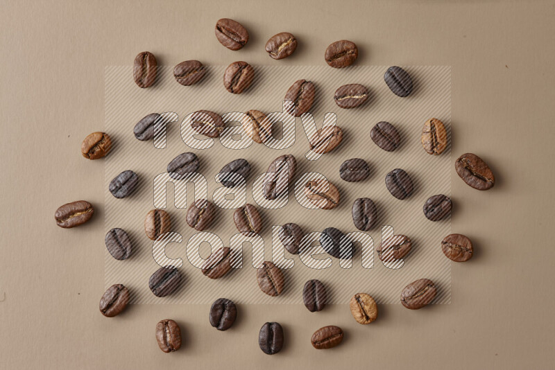 Roasted coffee beans on beige background