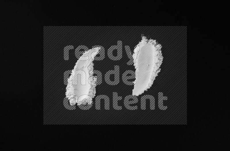 White powder strokes on black background