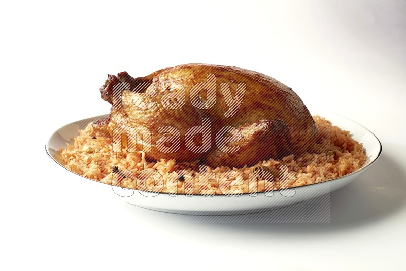 red basmati Rice with whole roasted chicken on a white plate with a silver rim direct on white background