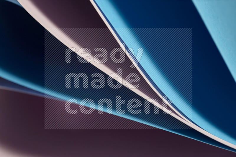 An abstract art showing purple and blue paper sheets arranged in an overlapping curves