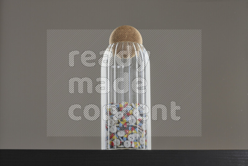 Buttons in a glass jar on black background