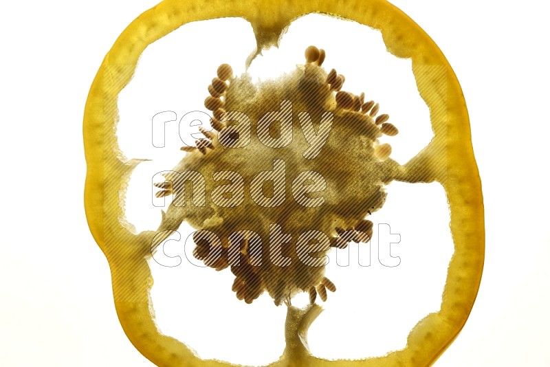 Yellow bell pepper slices on illuminated white background