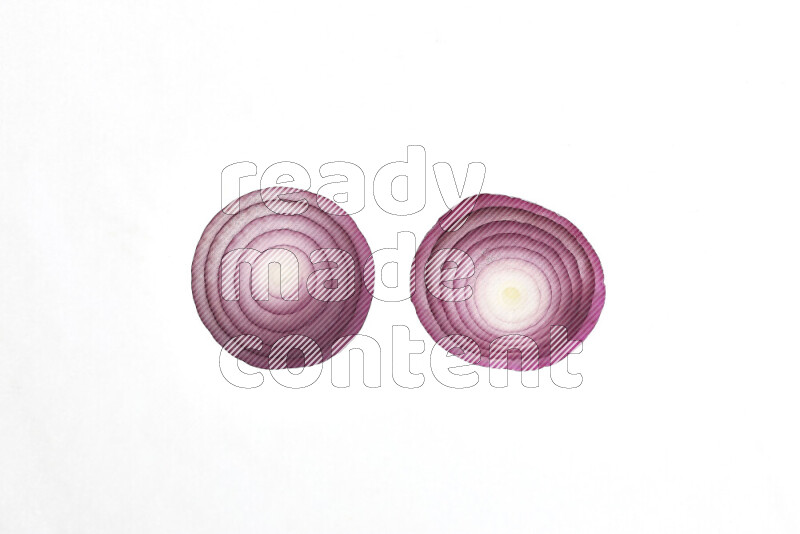 Onion slices on illuminated white background