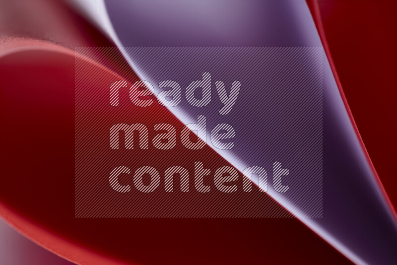 An abstract art showing purple and red paper sheets arranged in an overlapping curves