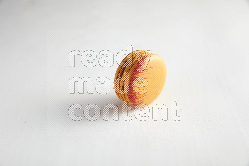 45º Shot of Orange Exotic macaron on white background