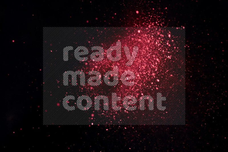 Red powder explosion on black background