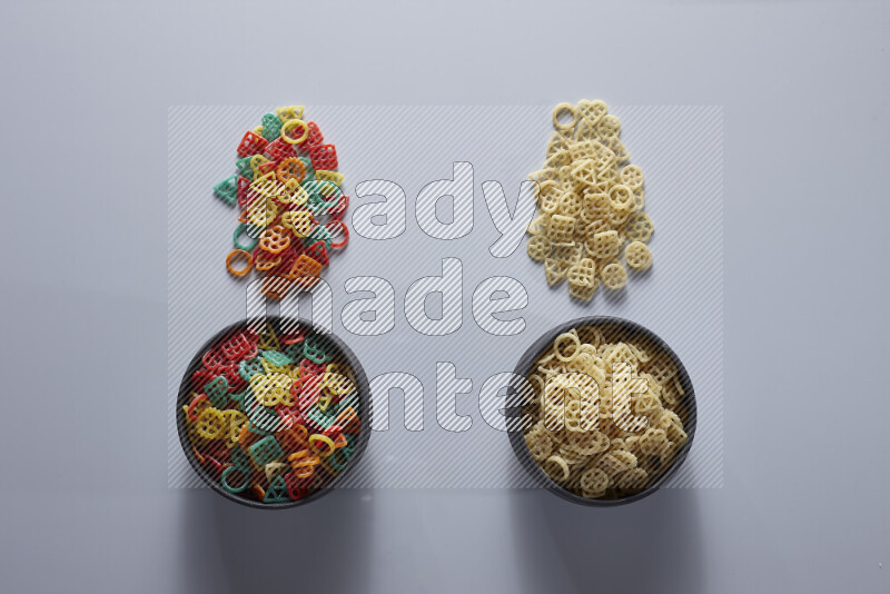 Legumes in pottery bowls on light grey background