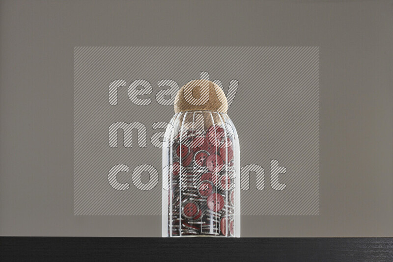 Buttons in a glass jar on black background