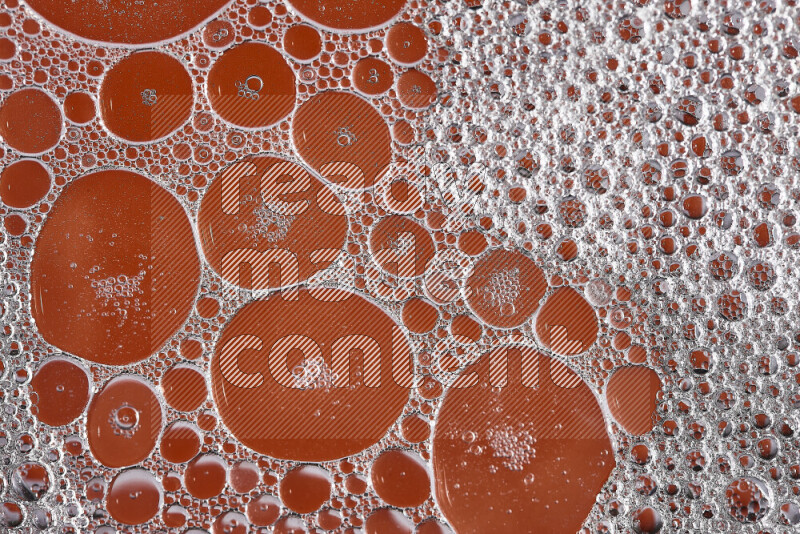 Close-ups of abstract soap bubbles and water droplets on orange background