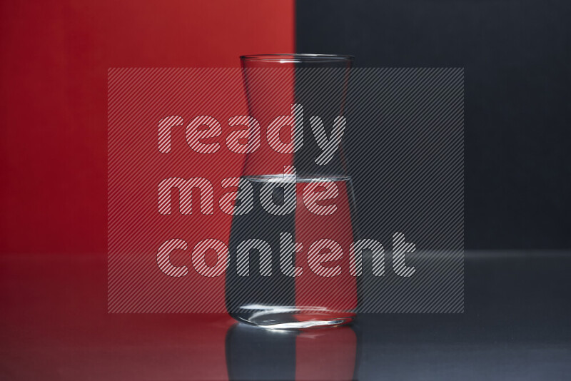 The image features a clear glassware filled with water, set against red and black background