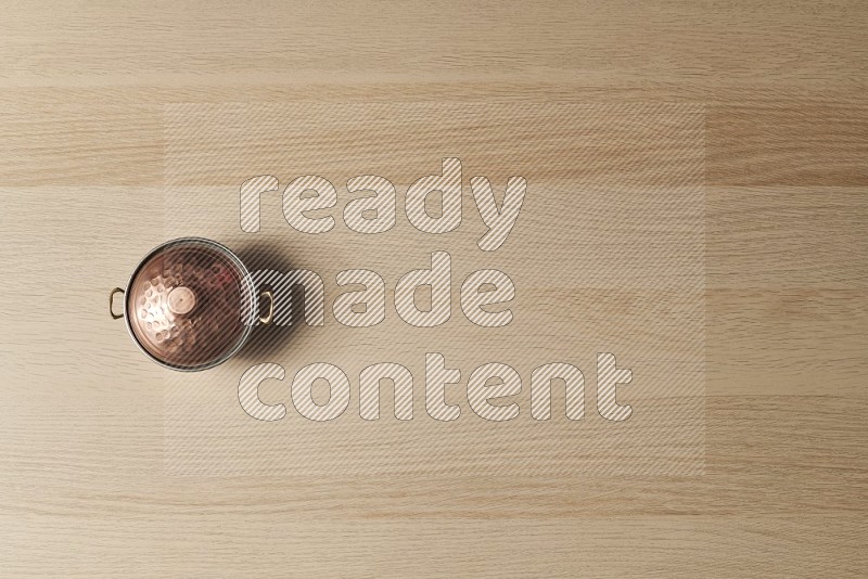 Top View Shot Of A Small Copper Pot on Oak Wooden Flooring