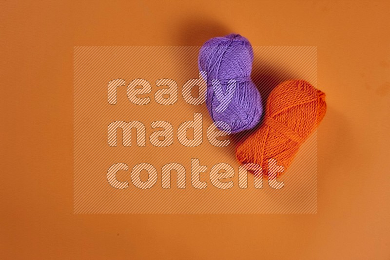 Purple sewing supplies on orange background