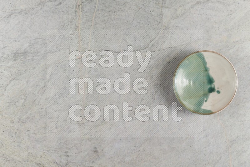 A multicolored pottery Bowl on grey marble background
