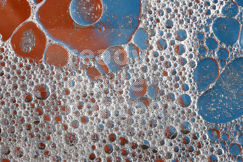 Close-ups of abstract soap bubbles and water droplets on orange and blue background