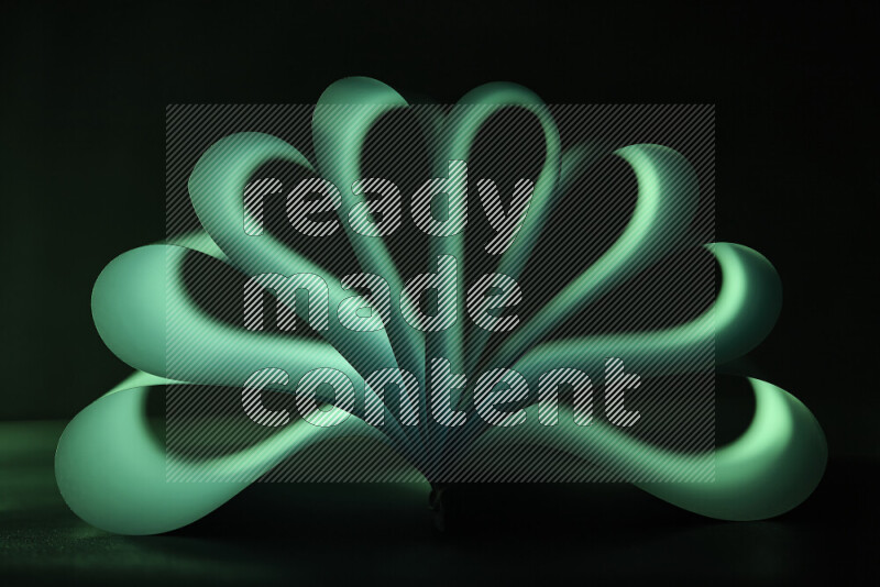 An abstract art piece displaying smooth curves in green gradients created by colored light