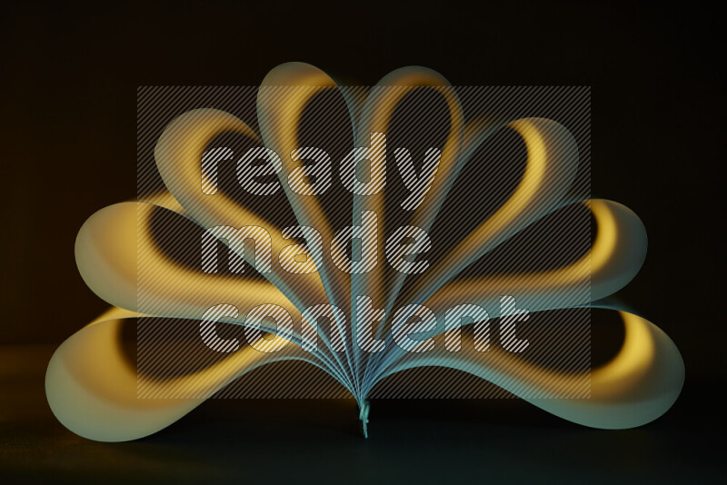 An abstract art piece displaying smooth curves in yellow and green gradients created by colored light