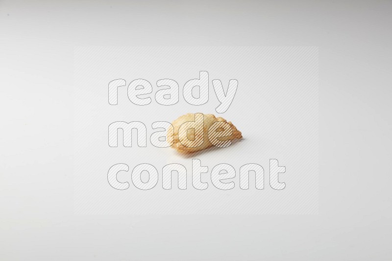 One fried sambosa on a white background