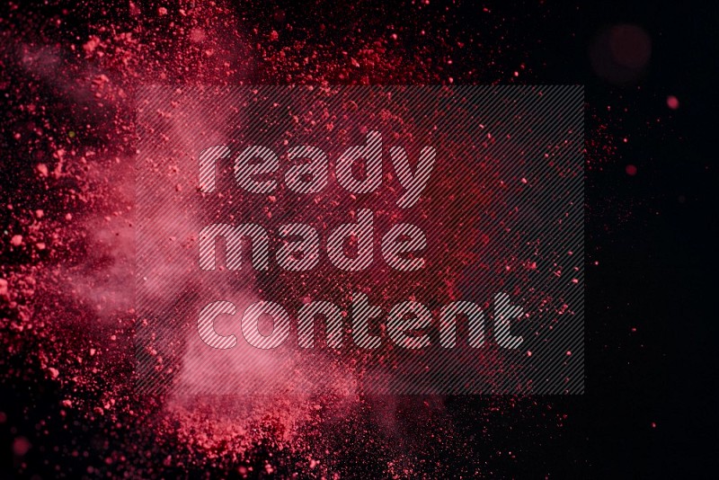 Red powder explosion on black background