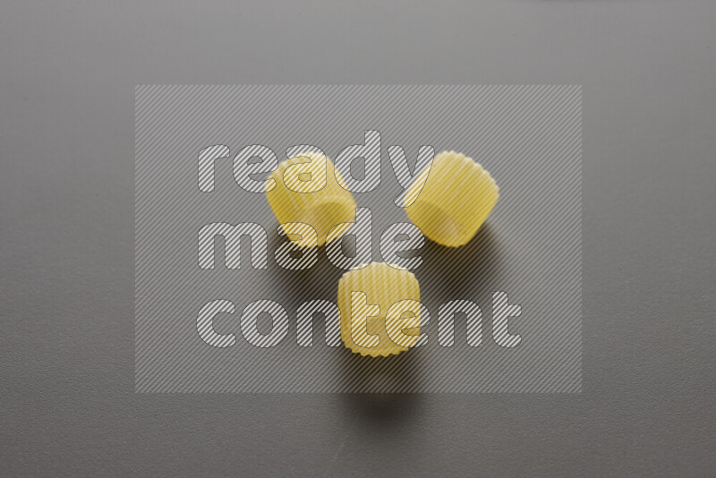 Big rings pasta on grey background