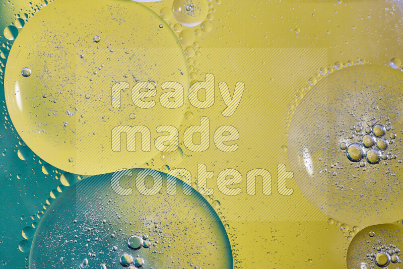 Close-ups of abstract oil bubbles on water surface in shades of green and yellow