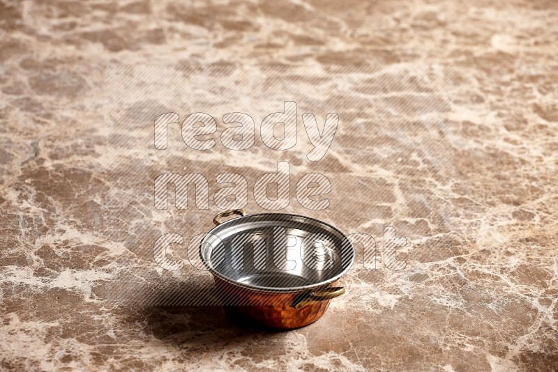 Small Copper Pot on Beige Marble Flooring, 45 degrees