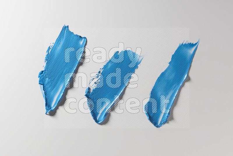 Blue painting knife strokes on a white background