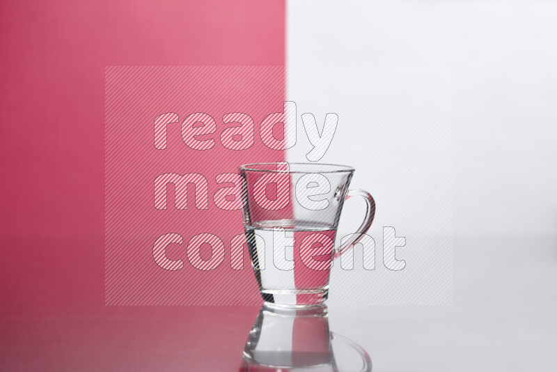 The image features a clear glassware filled with water, set against white and pink background