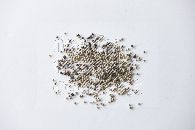 Mixed black and white pepper beads on a white flooring