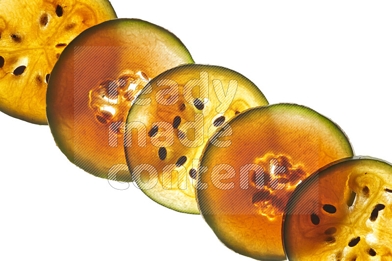 Mixed fruits slices on illuminated white background