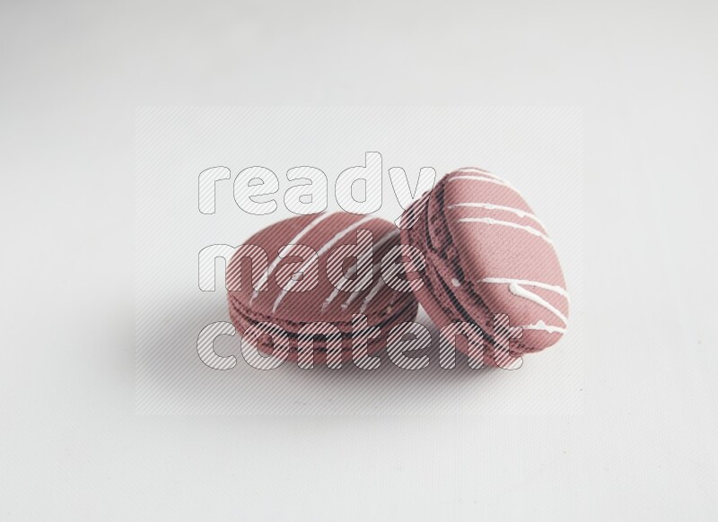 45º Shot of two Red Poppy Flower macarons on white background