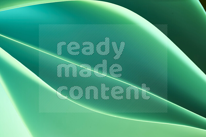 This image showcases an abstract paper art composition with paper curves in green gradients created by colored light