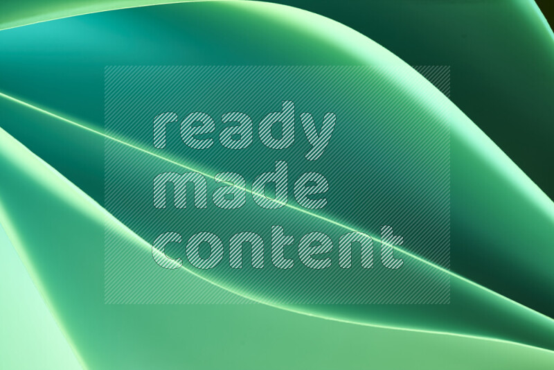 This image showcases an abstract paper art composition with paper curves in green gradients created by colored light