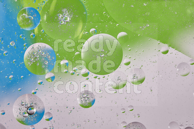 Close-ups of abstract oil bubbles on water surface in shades of white, green and blue