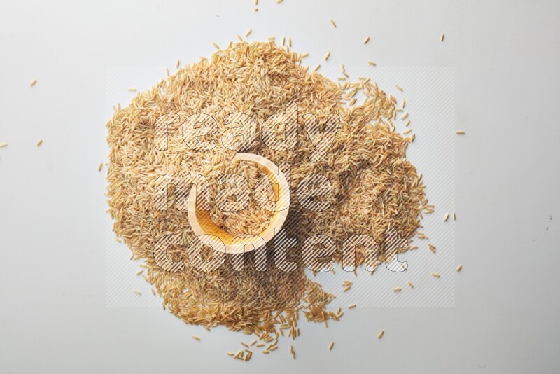 Top-view shot of long grain brown rice in a container on white background