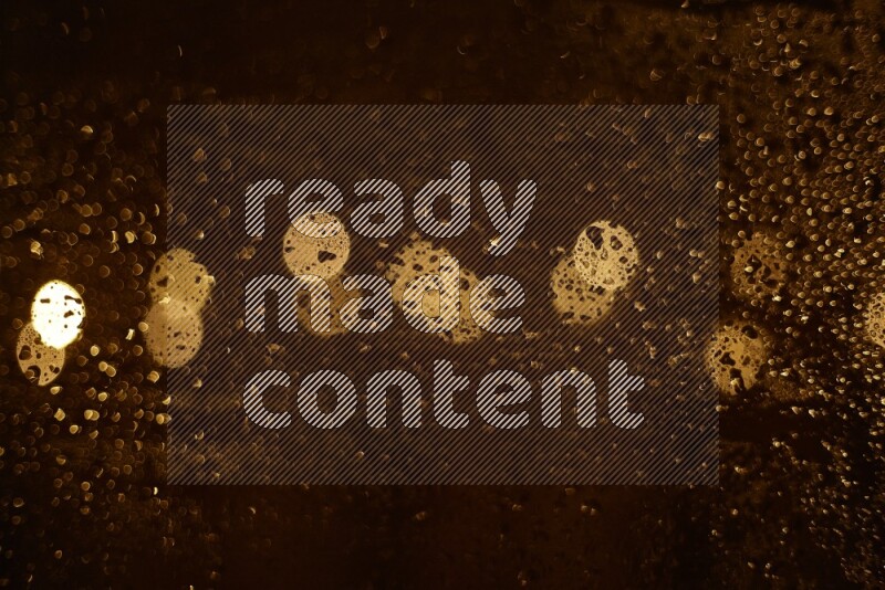 Bokeh light in yellow with water drops