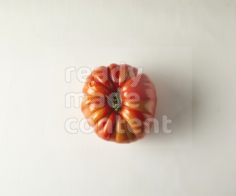 Single topview Heirloom tomato on a white backgrounds