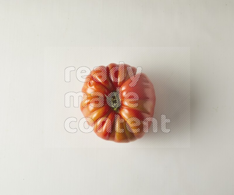 Single topview Heirloom tomato on a white backgrounds
