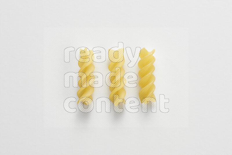 Fusilli pasta on white background