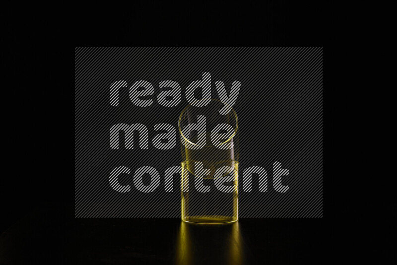 Glassware with rim light in yellow against black background